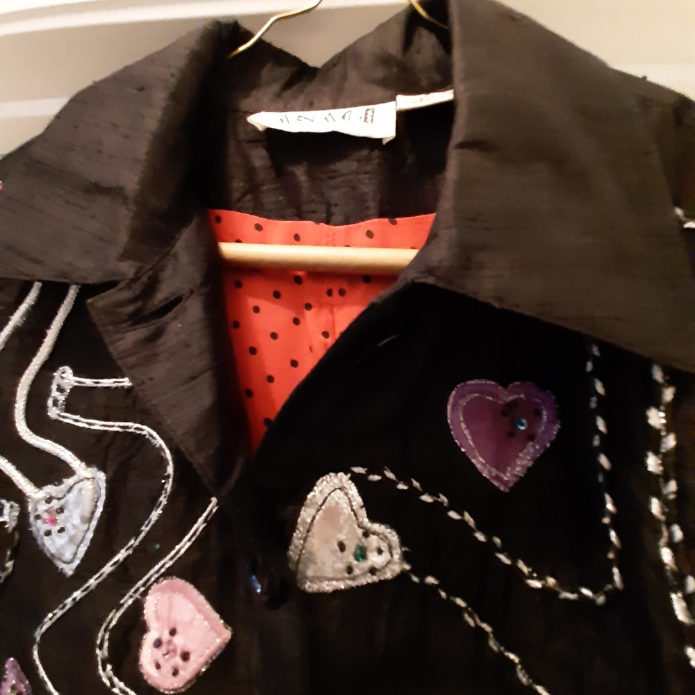 a black&silver jacket w red& black polka dot liner